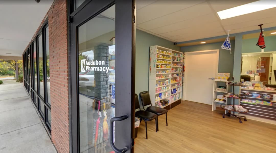 pharmacist greeting a patient inside Reich's Pharmacy
